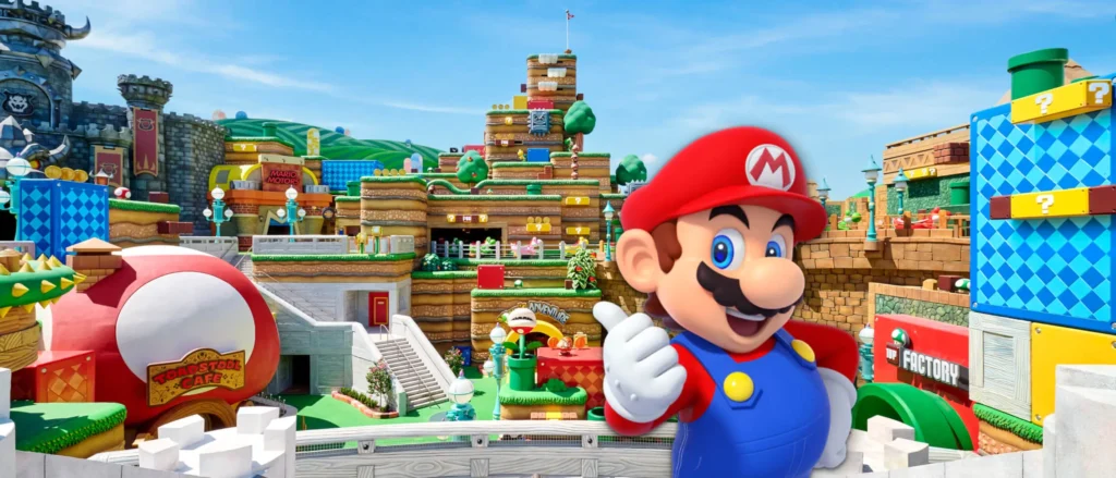 Mario devant le monde coloré de Super Nintendo World à Epic Universe, avec ses décors inspirés des jeux vidéo Nintendo.